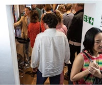 a crowd of people standing in a doorway