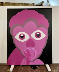 a painting with a pink face on it