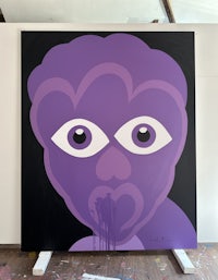 a painting with a purple face on it